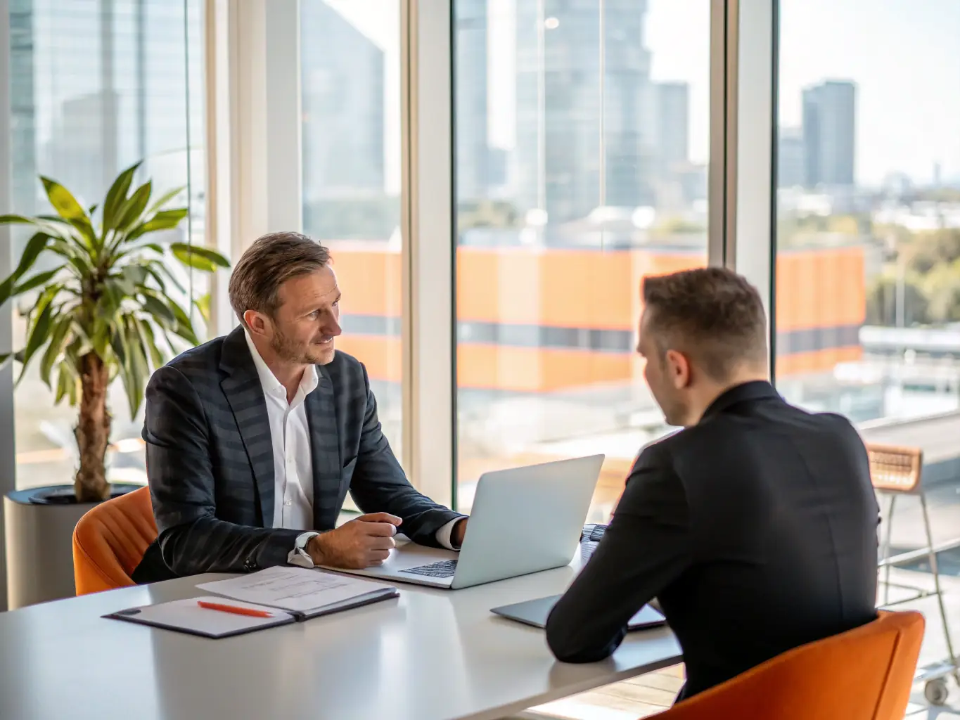 A professional business coach in a modern office setting, working with a client on a strategic plan, with subtle quantum physics visual elements in the background.